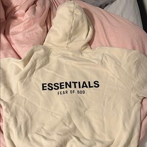 Fear of God Essentials Off-White Hoodie with Black Text